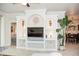 Bright living area featuring a custom shelving unit and view to the dining room at 6931 Surrey Hill Pl, Apollo Beach, FL 33572