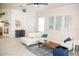 Bright living room with tile floors, white sofa, and natural light at 6931 Surrey Hill Pl, Apollo Beach, FL 33572