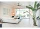 Bright living area with tile floors, white sofa, and sliders to the lanai at 6931 Surrey Hill Pl, Apollo Beach, FL 33572
