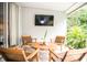 Relaxing covered patio features a stylish seating area with a mounted TV for outdoor enjoyment at 6931 Surrey Hill Pl, Apollo Beach, FL 33572