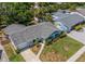 Aerial view of a charming single-story home, featuring a well-maintained yard and a classic roof design at 8421 Millwood Dr, Tampa, FL 33615