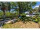 Large backyard featuring beautiful landscaping, a cozy fire pit and mature trees providing plenty of shade at 8421 Millwood Dr, Tampa, FL 33615