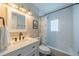 Bright bathroom featuring a vanity with drawers and a tub with white tiling at 8421 Millwood Dr, Tampa, FL 33615