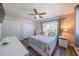 Bright bedroom with hardwood floors, one window, and a neutral colored bedspread at 8421 Millwood Dr, Tampa, FL 33615