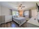 Cozy bedroom with hardwood floors, two windows, and a neutral colored bedspread at 8421 Millwood Dr, Tampa, FL 33615