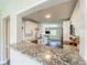 Modern kitchen featuring granite countertops, stainless steel appliances, and white cabinetry at 8421 Millwood Dr, Tampa, FL 33615