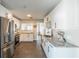 Spacious kitchen featuring stainless steel appliances, granite countertops, and white cabinetry at 8421 Millwood Dr, Tampa, FL 33615
