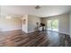 Bright, open-concept living area featuring laminate flooring and a sliding glass door for seamless indoor-outdoor flow at 8421 Millwood Dr, Tampa, FL 33615