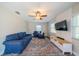 Spacious living room with hardwood floors, ceiling fan, and comfortable blue furniture at 8421 Millwood Dr, Tampa, FL 33615