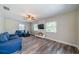 Bright living room with hardwood floors, white brick accent wall, and comfortable blue furniture at 8421 Millwood Dr, Tampa, FL 33615