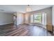 Inviting living room with laminate flooring, a large window with lots of natural light, and modern light fixtures at 8421 Millwood Dr, Tampa, FL 33615