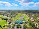 Aerial view of a community featuring a clubhouse, golf course, ponds and picturesque surroundings at 8703 Bardmoor Blvd # 304, Seminole, FL 33777