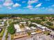 Expansive aerial showcasing the apartment complex, surrounding trees, and neighborhood at 8703 Bardmoor Blvd # 304, Seminole, FL 33777