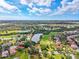An aerial view of houses, golf courses, lakes, ponds and lush vegetation set amongst a community at 8703 Bardmoor Blvd # 304, Seminole, FL 33777