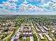 Wide aerial shot featuring community layout, including swimming pools, lush greenery, and well-connected roads at 8703 Bardmoor Blvd # 304, Seminole, FL 33777