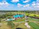 High aerial showcasing the clubhouse, swimming pool, and lush greenery, providing a resort-like community experience at 8703 Bardmoor Blvd # 304, Seminole, FL 33777