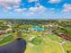 Stunning aerial view of a golf course with a clubhouse, meticulously manicured greens, and serene water features at 8703 Bardmoor Blvd # 304, Seminole, FL 33777