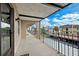 A balcony with metal railing overlooks neighborhood and sky with clouds at 8703 Bardmoor Blvd # 304, Seminole, FL 33777