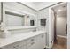Bright bathroom featuring a spacious vanity with white countertops, modern fixtures, and great lighting at 8703 Bardmoor Blvd # 304, Seminole, FL 33777