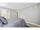 Neutral bedroom with a large bed, soft lighting, and convenient access to the bathroom at 8703 Bardmoor Blvd # 304, Seminole, FL 33777