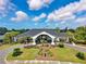 Elegant clubhouse exterior featuring manicured landscaping, a circular driveway, and inviting entrance for residents and guests at 8703 Bardmoor Blvd # 304, Seminole, FL 33777
