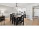 Dining room area featuring hardwood floors, modern lighting, and easy access to the kitchen at 8703 Bardmoor Blvd # 304, Seminole, FL 33777