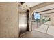 Building elevator on a stucco covered landing with wrought iron decorative railing on covered exterior walkway at 8703 Bardmoor Blvd # 304, Seminole, FL 33777