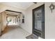 Exterior entrance of condo featuring a secure glass door, welcome mat, and walkway at 8703 Bardmoor Blvd # 304, Seminole, FL 33777