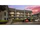 Condominium exterior with assigned covered parking and mature landscaping at 8703 Bardmoor Blvd # 304, Seminole, FL 33777