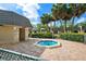 Inviting outdoor hot tub area complete with brick pavers, privacy fencing, and lush palm trees for a relaxing retreat at 8703 Bardmoor Blvd # 304, Seminole, FL 33777