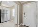 The kitchen entryway features stainless steel refrigerator, modern white cabinetry and is adjacent to the entrance at 8703 Bardmoor Blvd # 304, Seminole, FL 33777