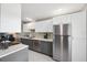 Clean kitchen features stainless steel appliances and white and gray color scheme at 8703 Bardmoor Blvd # 304, Seminole, FL 33777