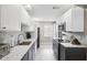 Bright eat-in kitchen features white upper cabinets and gray lower cabinets at 8703 Bardmoor Blvd # 304, Seminole, FL 33777