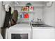 Laundry room featuring white washer and dryer, wire rack storage with cleaning supplies and cleaning tools at 8703 Bardmoor Blvd # 304, Seminole, FL 33777