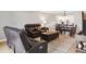 Open-concept living room features leather reclining sofa and dining area at 8703 Bardmoor Blvd # 304, Seminole, FL 33777