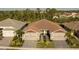A bird's eye view highlighting this paired villa's layout, landscaping, and surrounding neighborhood at 8732 Rain Song Rd, Sarasota, FL 34238