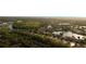 Lovely aerial view of the neighborhood featuring mature trees, water features, and natural landscaping at 8732 Rain Song Rd, Sarasota, FL 34238