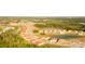 Beautiful aerial of a brand new community with some homes still under construction near a pond at 8732 Rain Song Rd, Sarasota, FL 34238