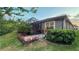 Backyard featuring a screened patio and neatly landscaped yard with flower beds at 8732 Rain Song Rd, Sarasota, FL 34238