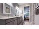 Dual vanity bathroom features granite countertops and stylish wall decor at 8732 Rain Song Rd, Sarasota, FL 34238