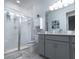 Bright bathroom with modern vanity, enclosed shower, and neutral color palette at 8732 Rain Song Rd, Sarasota, FL 34238