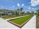Outdoor bocce ball courts with manicured lawns and clubhouse at 8732 Rain Song Rd, Sarasota, FL 34238