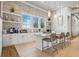 Coffee and snack bar area with white cabinets, shelves, and an island with seating at 8732 Rain Song Rd, Sarasota, FL 34238