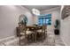 Dining room with decorative mirror, stylish table, chairs and modern lighting at 8732 Rain Song Rd, Sarasota, FL 34238