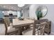 Dining room with decorative mirror, table with decor, chairs and kitchen view at 8732 Rain Song Rd, Sarasota, FL 34238