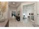 Spacious hallway featuring tray ceilings, neutral tones, and stylish decor leading to a bright living area at 8732 Rain Song Rd, Sarasota, FL 34238