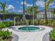 Relaxing outdoor hot tub surrounded by lush landscaping and paved walkways at 8732 Rain Song Rd, Sarasota, FL 34238