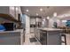 A beautifully appointed kitchen with stainless steel appliances, a central island, and tiled floors at 8732 Rain Song Rd, Sarasota, FL 34238