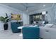Inviting living room featuring a gray sectional sofa, blue accent chairs, and modern decor at 8732 Rain Song Rd, Sarasota, FL 34238
