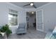 Cozy living room area featuring a comfortable armchair, stylish decor, and plenty of natural light at 8732 Rain Song Rd, Sarasota, FL 34238